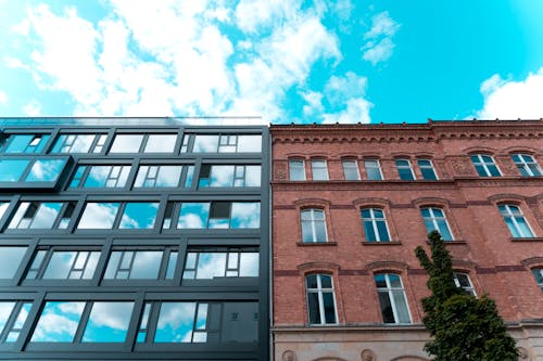 Low Angle Photo of Two Adjacent Apartment Buildings