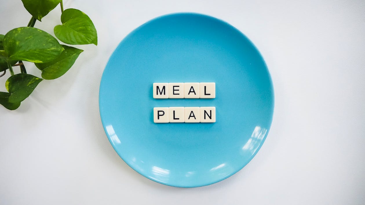 Free Blue Ceramic Plate With Meal Plan Blocks Stock Photo