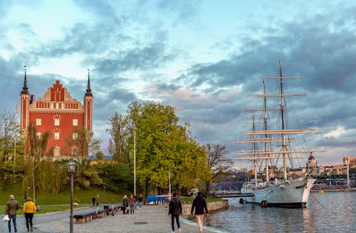 People Walking Near Body of Water