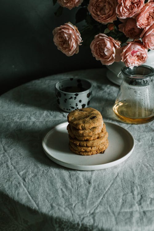 Baked Cookies on Plate Beside Teapot