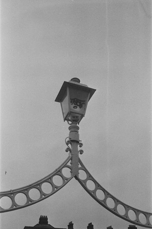 A black and white photo of a lamp post