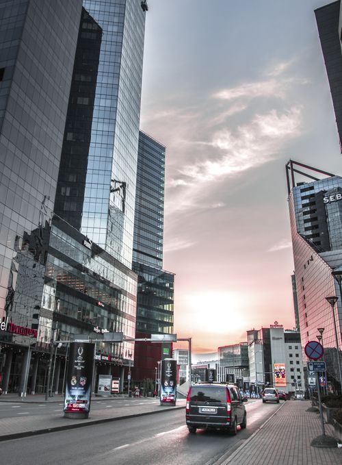 Free Urban cityscape of Tallinn with modern skyscrapers and sunset sky reflecting on buildings. Stock Photo