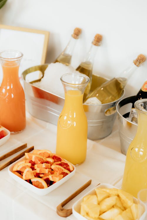 A table with fruit and juice in glasses