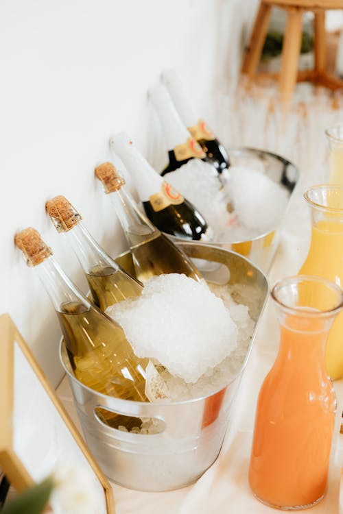 A table with bottles of champagne and orange juice