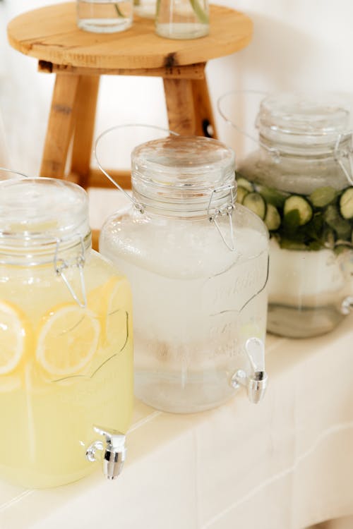 A table with jars of lemonade and water