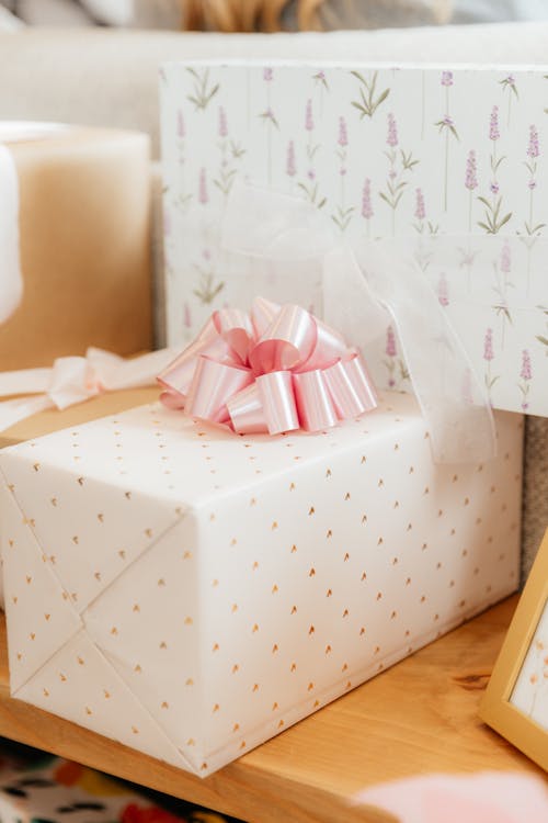 A gift box with a bow on it sits on a table