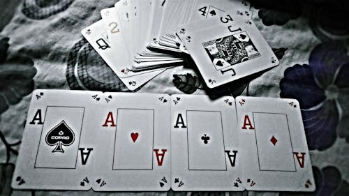 Grayscale Photography of Playing Cards Placed on Cloth