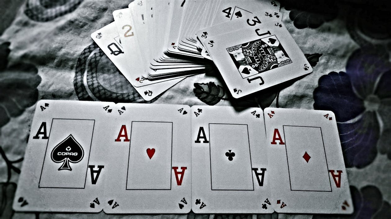 Grayscale Photography of Playing Cards Placed on Cloth