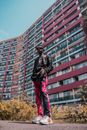 Low Angle Photo of Man Standing In Front of an Apartment Building