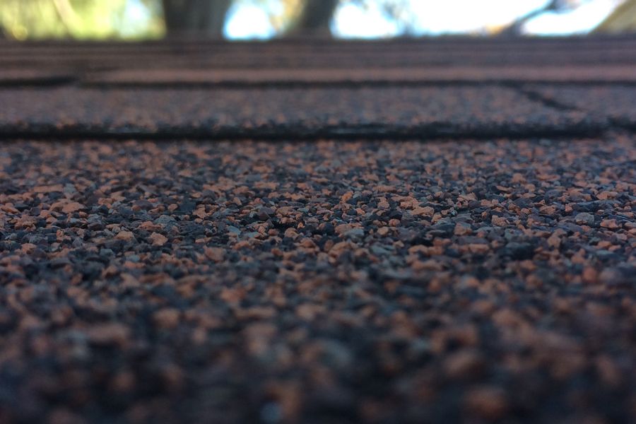 Close-up of overlapping asphalt roof shingles