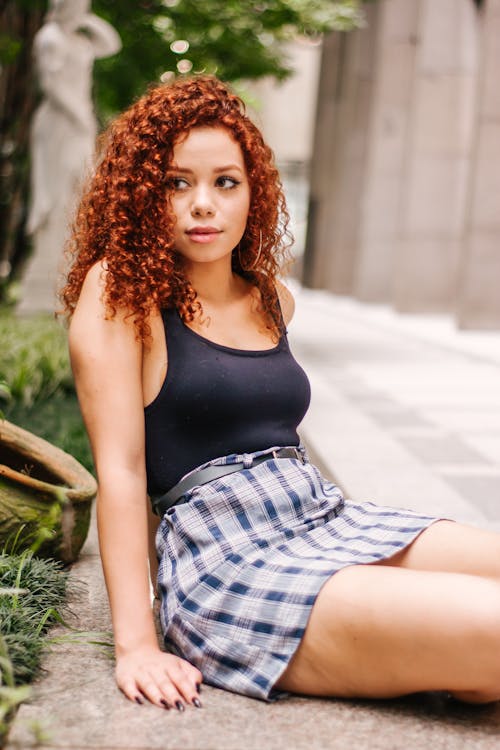 Woman Sitting on Selective Focus Photography