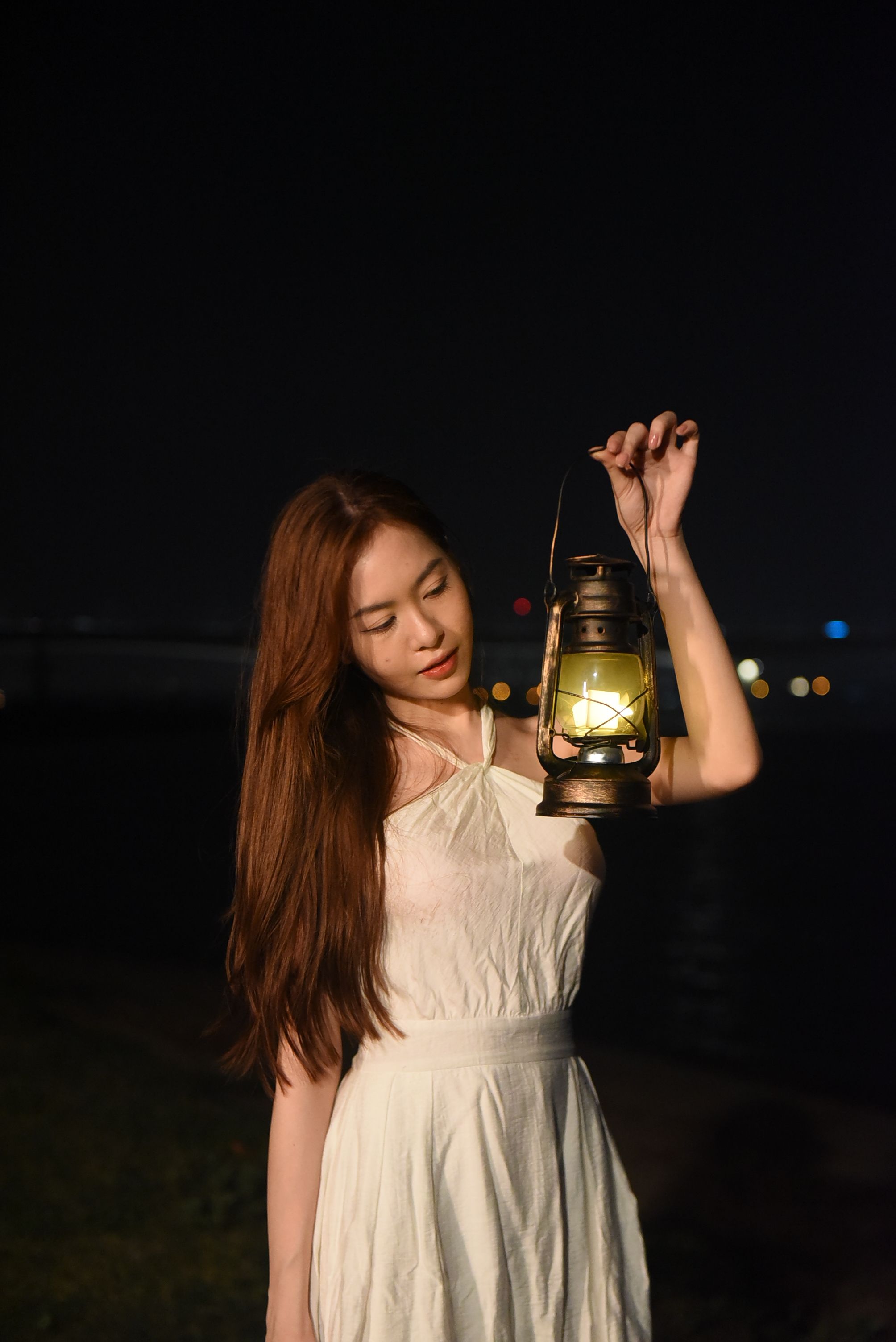 Woman in White Dress Holding Lantern at Night · Free Stock Photo