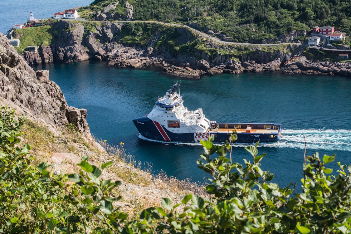 White and Blue Boat on Body of Water