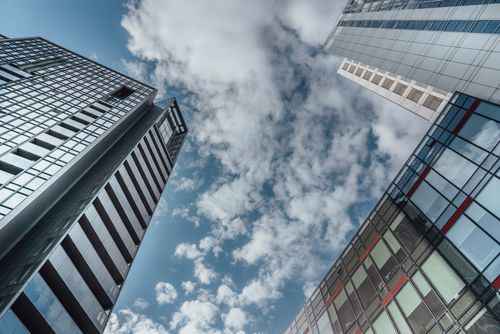Free Dynamic view of Poznań skyscrapers against a cloudy blue sky, showcasing modern architecture. Stock Photo