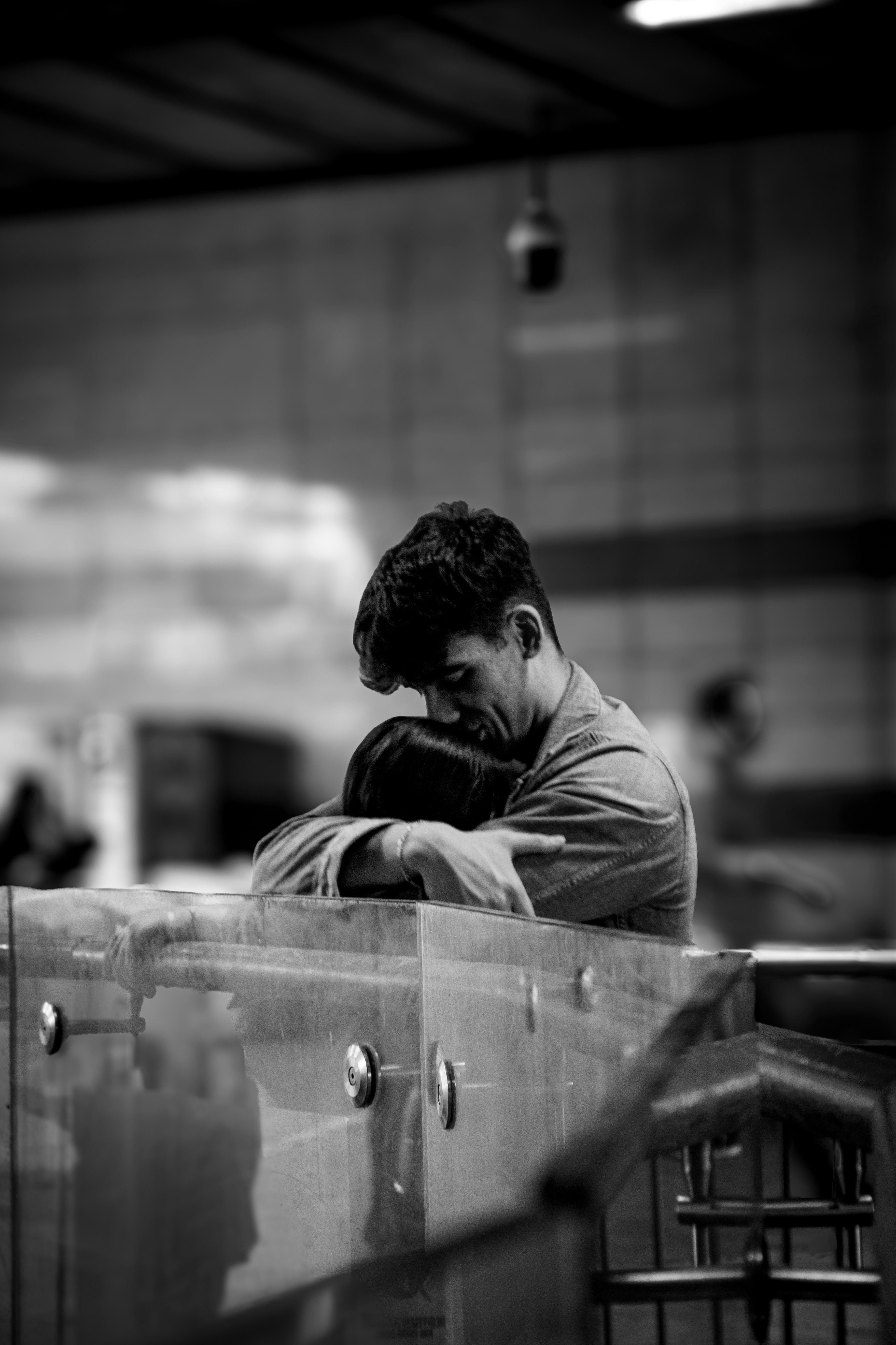 A Man Hugging Woman at a Subway Station, Black And White · Free Stock Photo