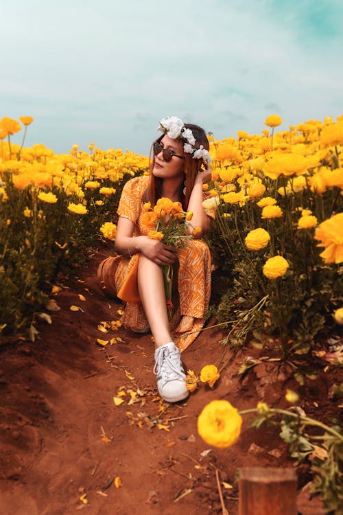 Unknown Celebrity Sitting Beside Yellow Flower Fields