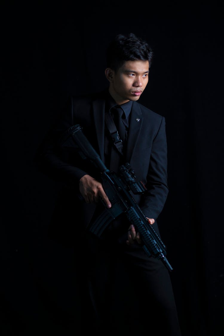 Man Wearing Black Suit And Carrying M4 Carbine With Scope