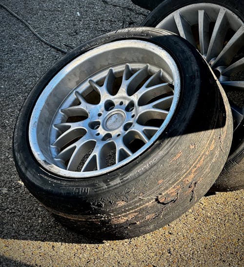 A tire and rim sitting on the ground