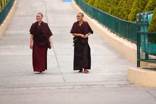 Photo of Two Monks Walking on Street