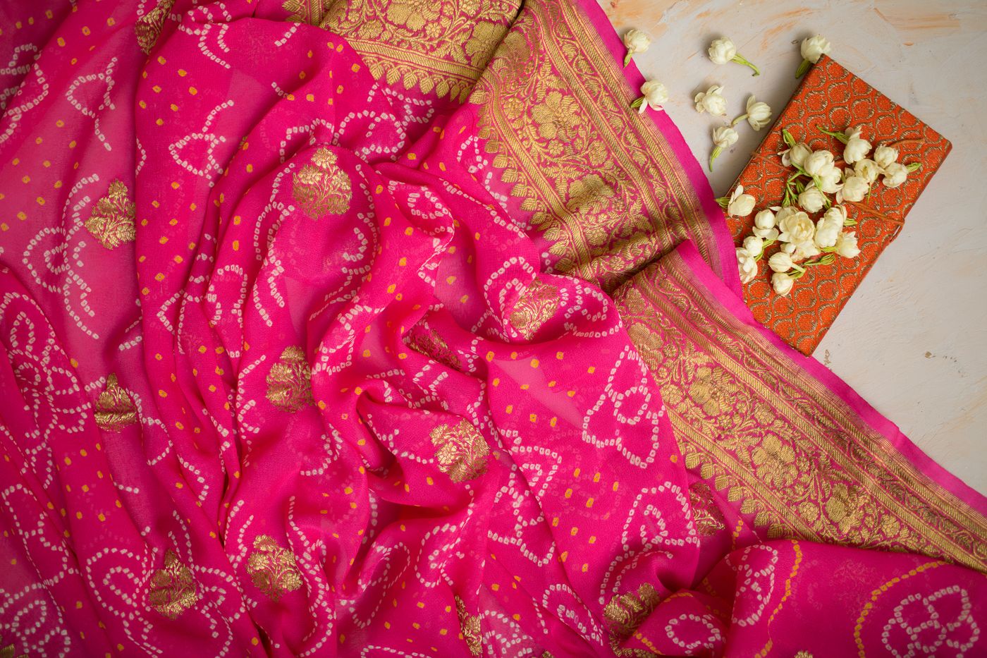 Pink textile with gold floral embroidery