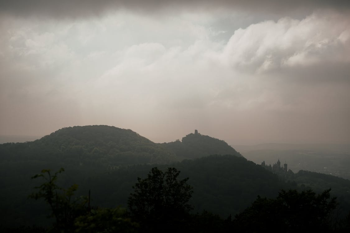 A view of a mountain with a cloudy sky
