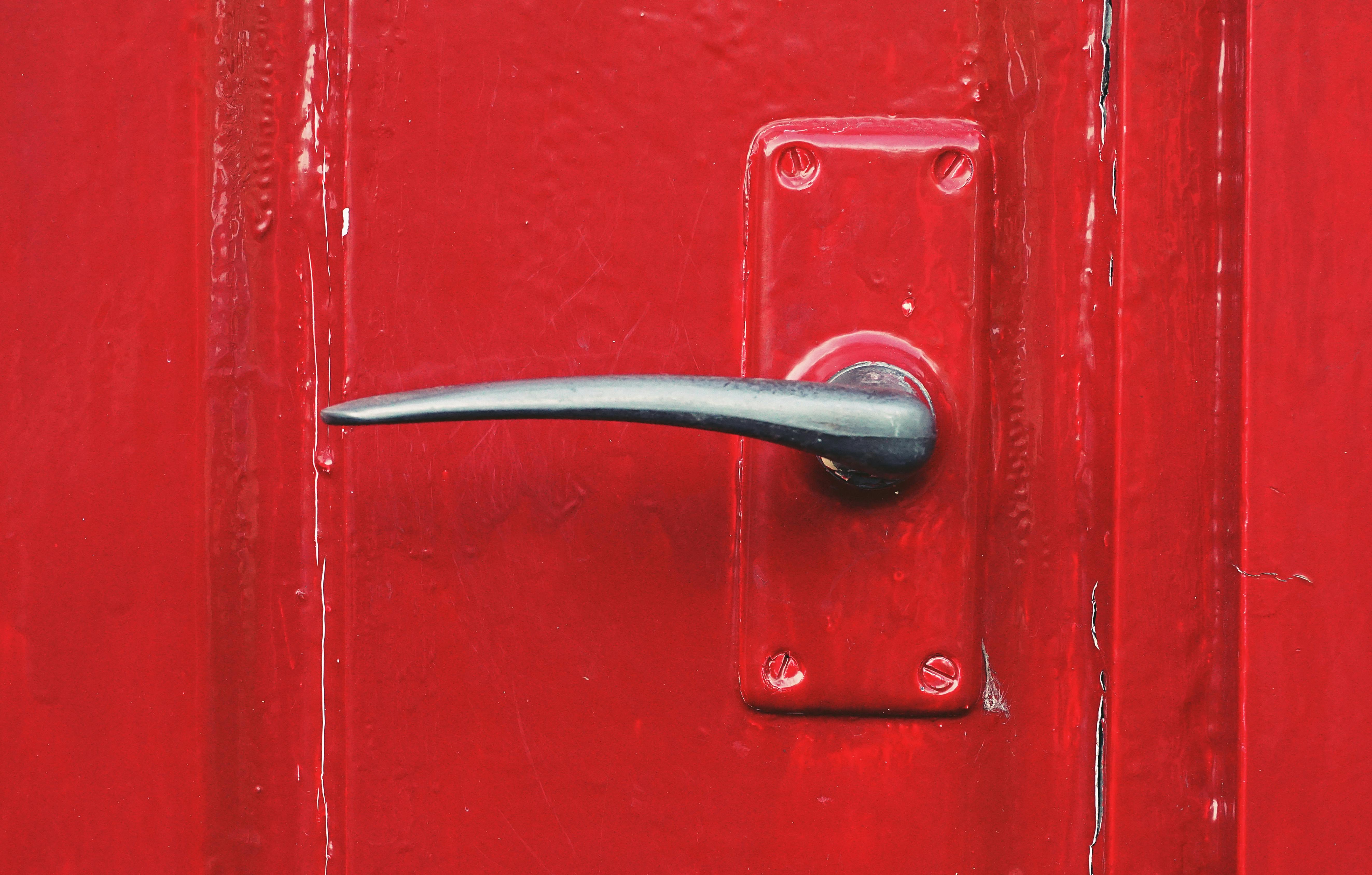metal door handle on a red door