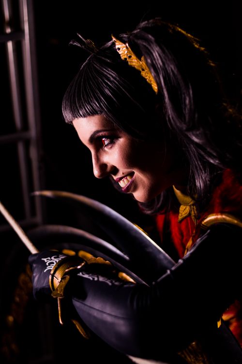 Free Close-up of a woman in cosplay with intense makeup and vibrant costume in a studio setting. Stock Photo