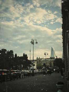 A picturesque street view in Baku featuring Flame Towers and city skyline.