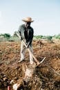 Photo of Man Standing While Holding Pickaxe