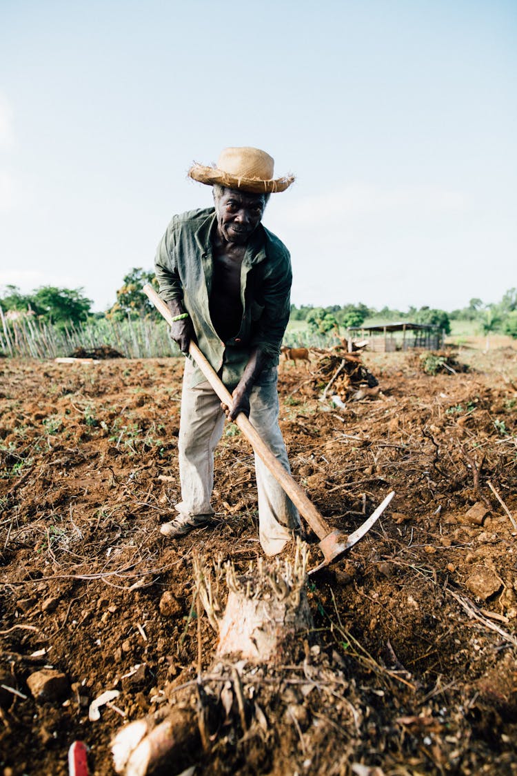 Photo Of Man Standing While Holding Pickaxe