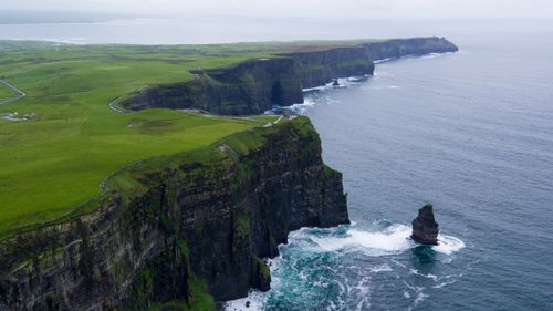 Free Stunning aerial view of the Cliffs of Moher, County Clare, Ireland with lush green landscapes and ocean waves. Stock Photo