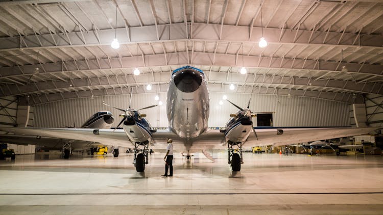 Gray Plane Inside Hangar