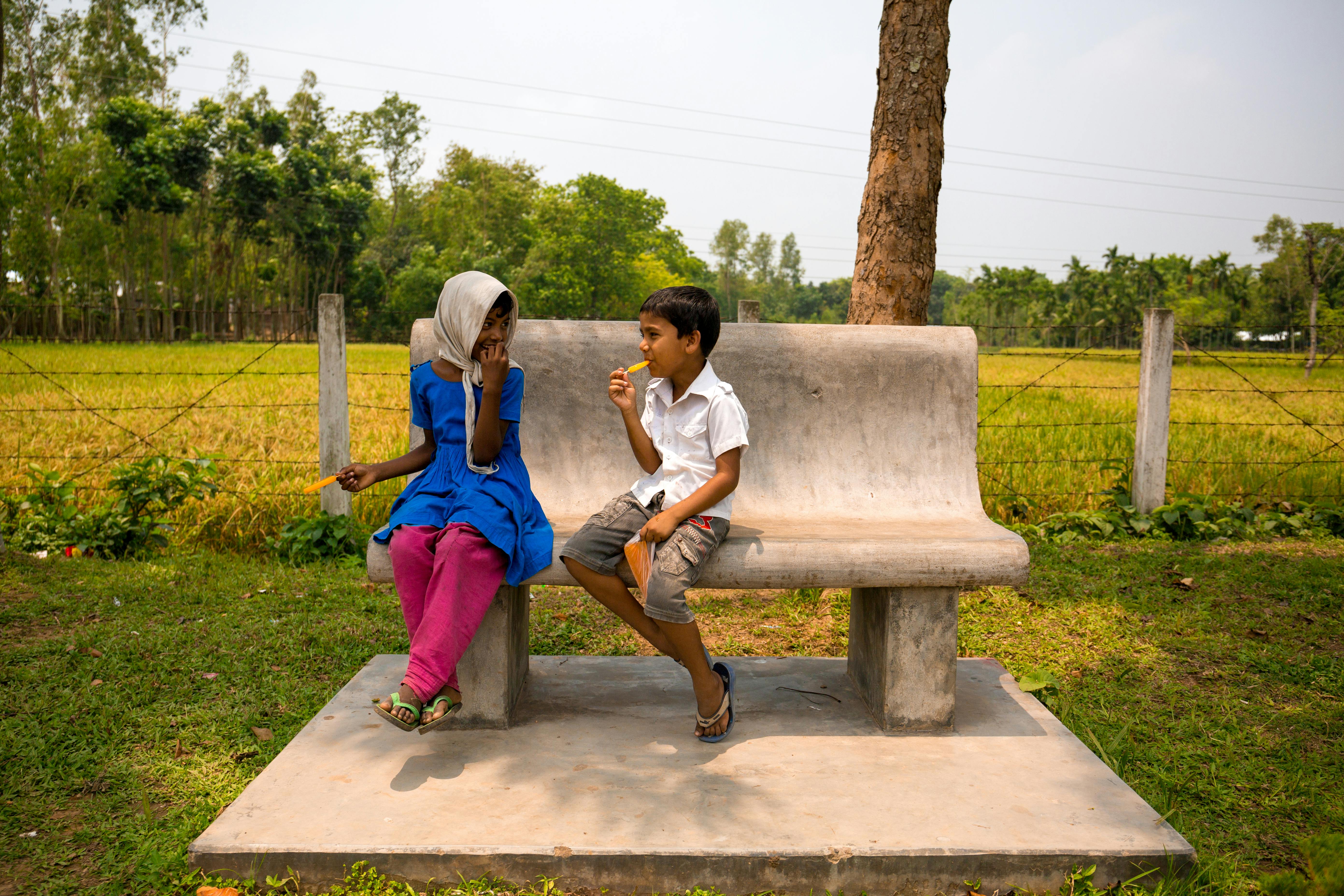 children sitting on bench