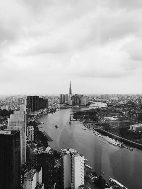 Monochrome cityscape showing a river and skyline. Ideal for business and urban themes.