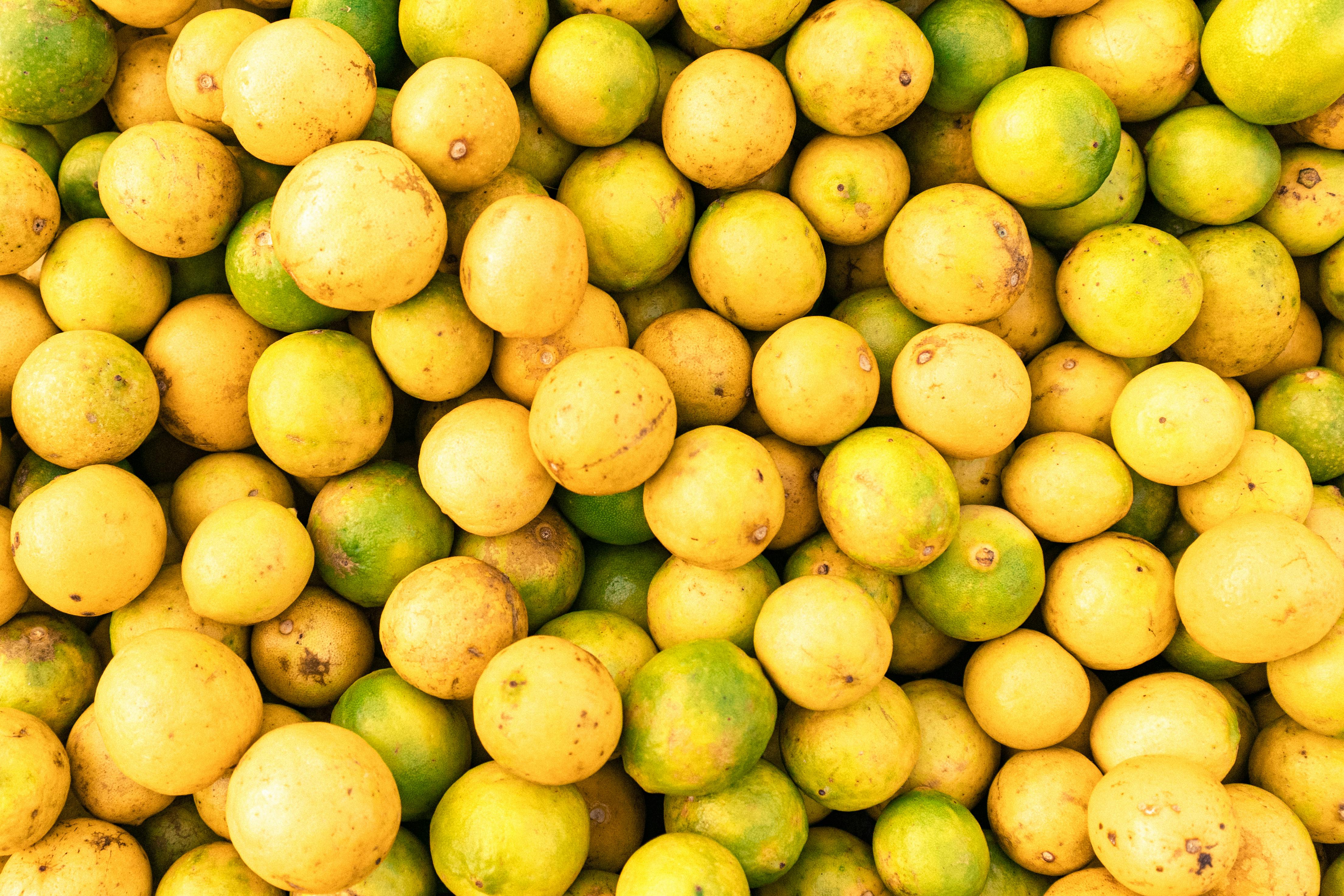 A vibrant display of ripe yellow lemons, showcasing freshness at an Indian market.
