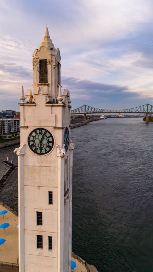A clock tower is next to a river