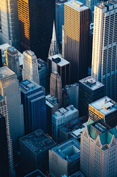 Dramatic aerial view of Chicago's iconic skyscrapers at twilight, showcasing urban architecture.