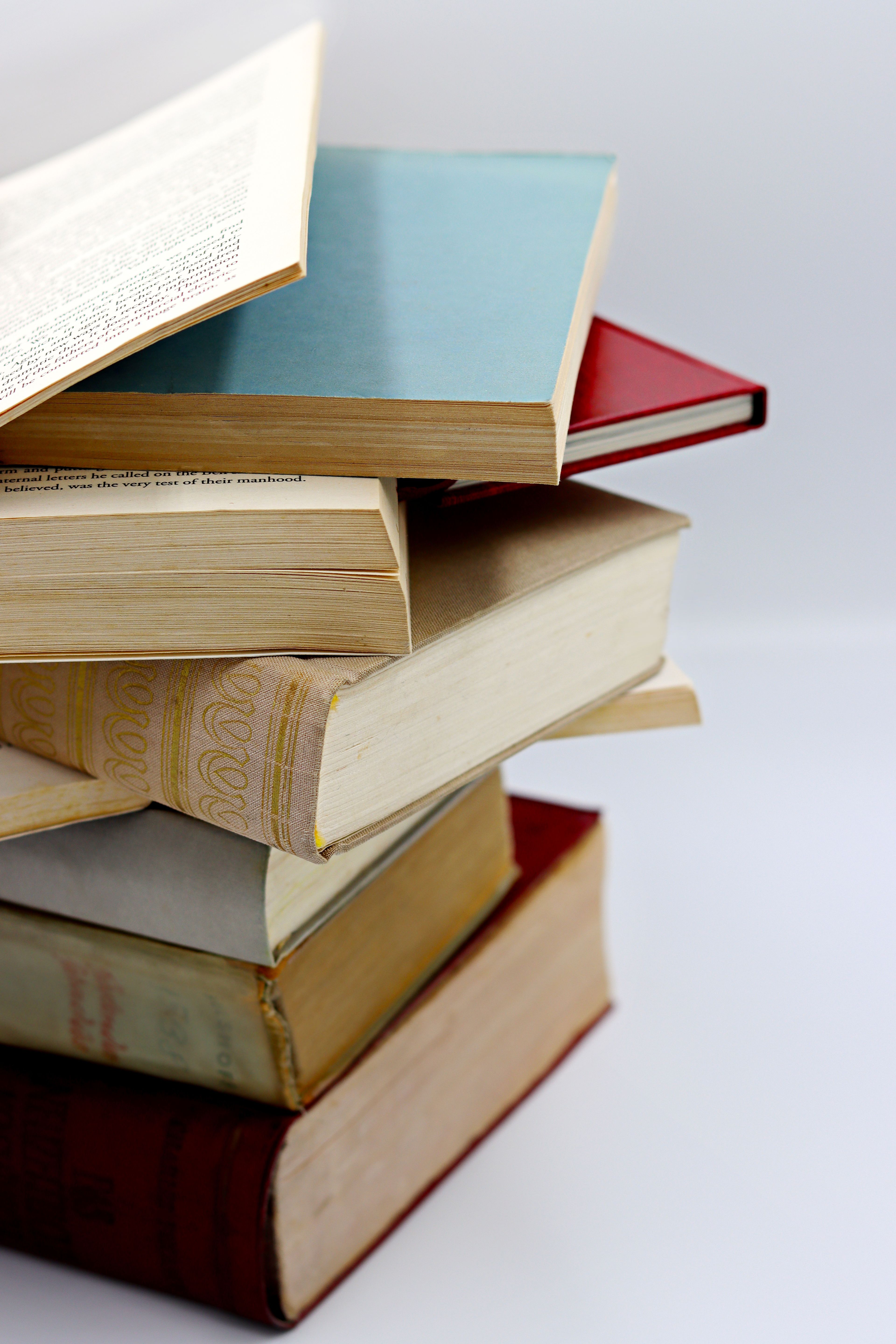A close stack of hardback books with gilded page edges