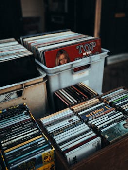 Collection of vinyl records and CDs in a vintage market shop, showcasing retro music nostalgia.