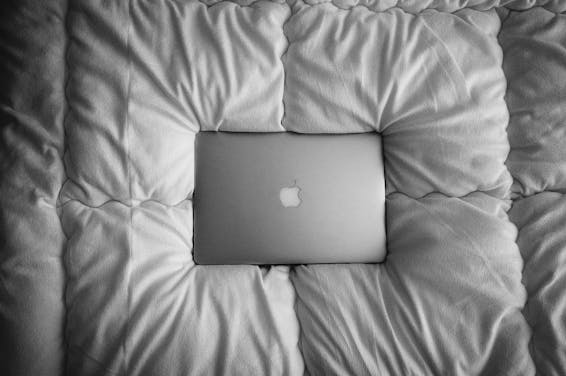 Silver Macbook on White Cushion
