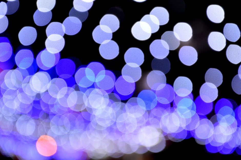 Abstract bokeh with blue and white circular lights creating a vibrant pattern.