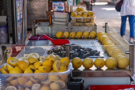 Street stall in İzmir showcasing fresh lemons and stuffed mussels, capturing vibrant market life.