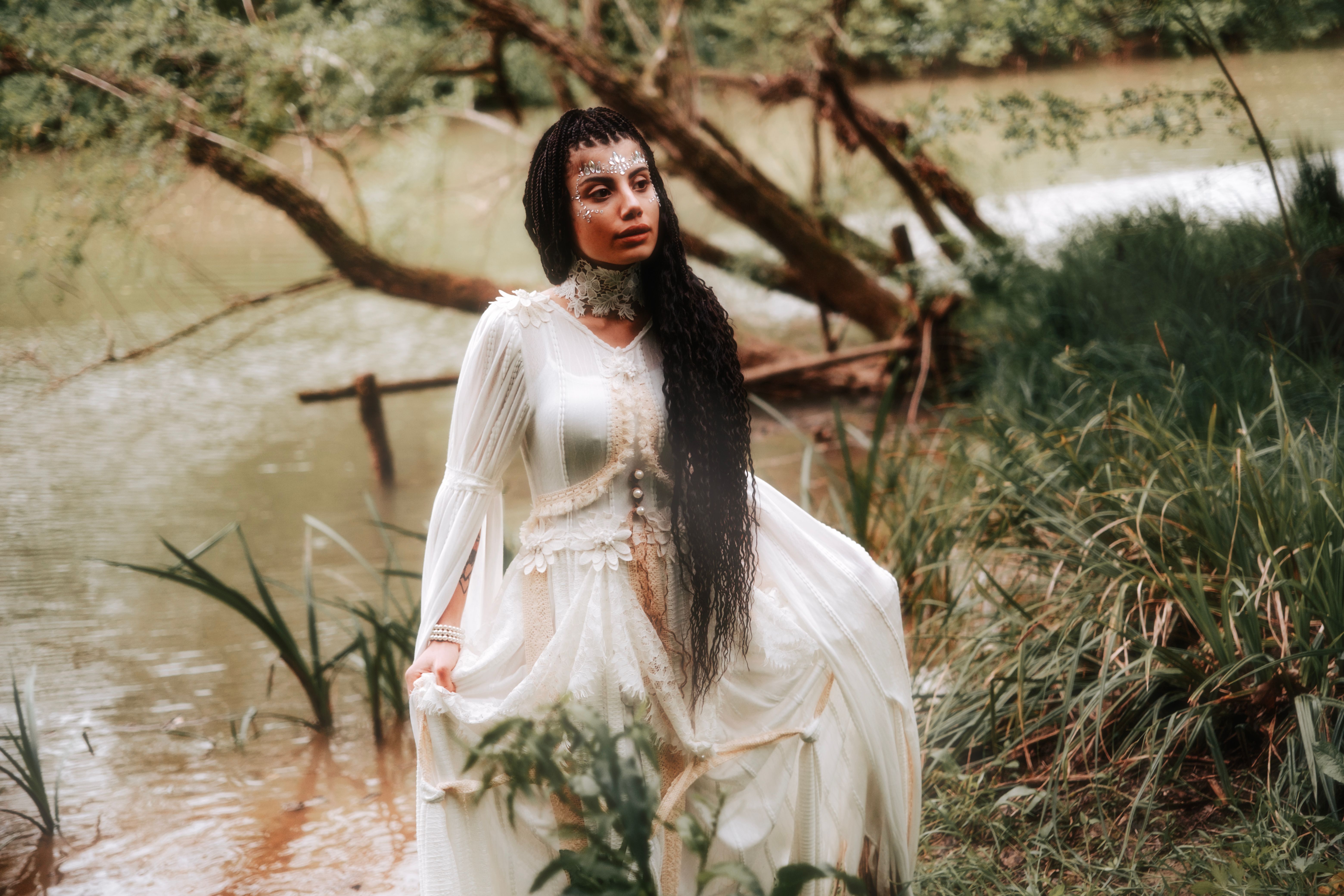 A woman in a white dress standing in the water · Free Stock Photo