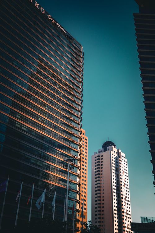 Free A scenic view of modern skyscrapers against a clear blue sky, showcasing urban architecture. Stock Photo