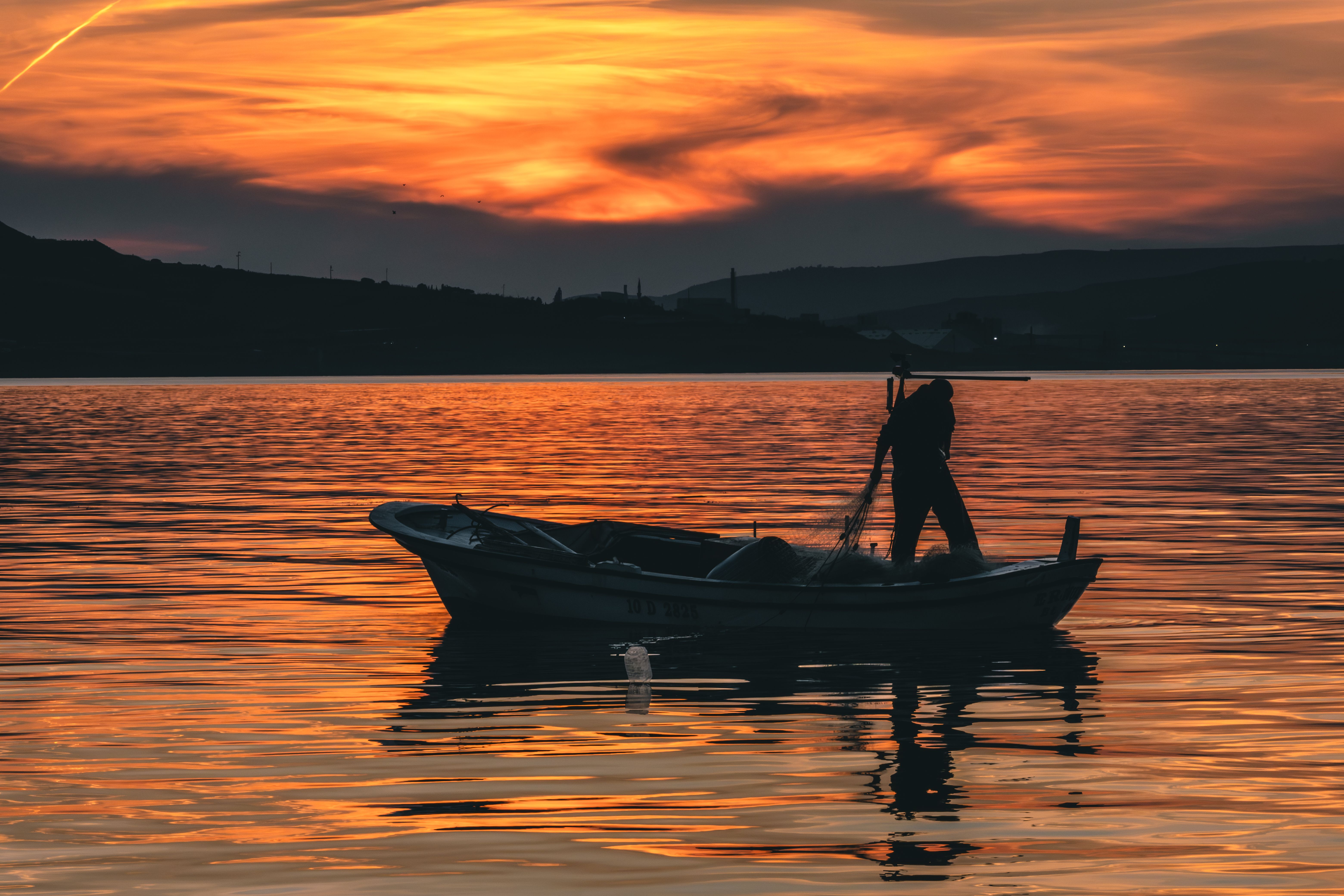 Silhouette Of Man On Boat In Water · Free Stock Photo