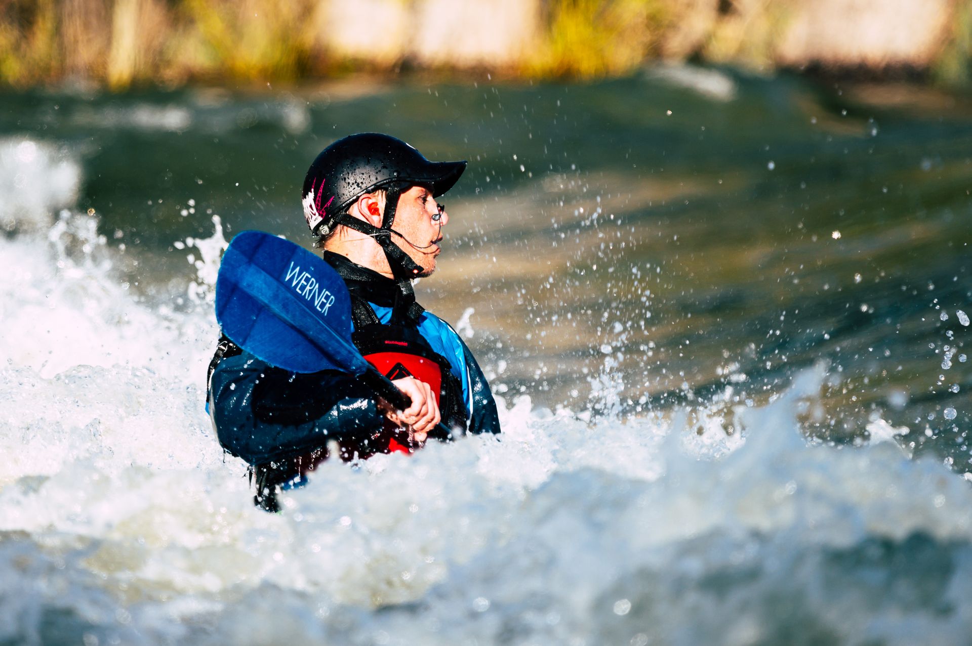 A man navigates through challenging whitewater rapids, demonstrating skill and excitement in kayaking.