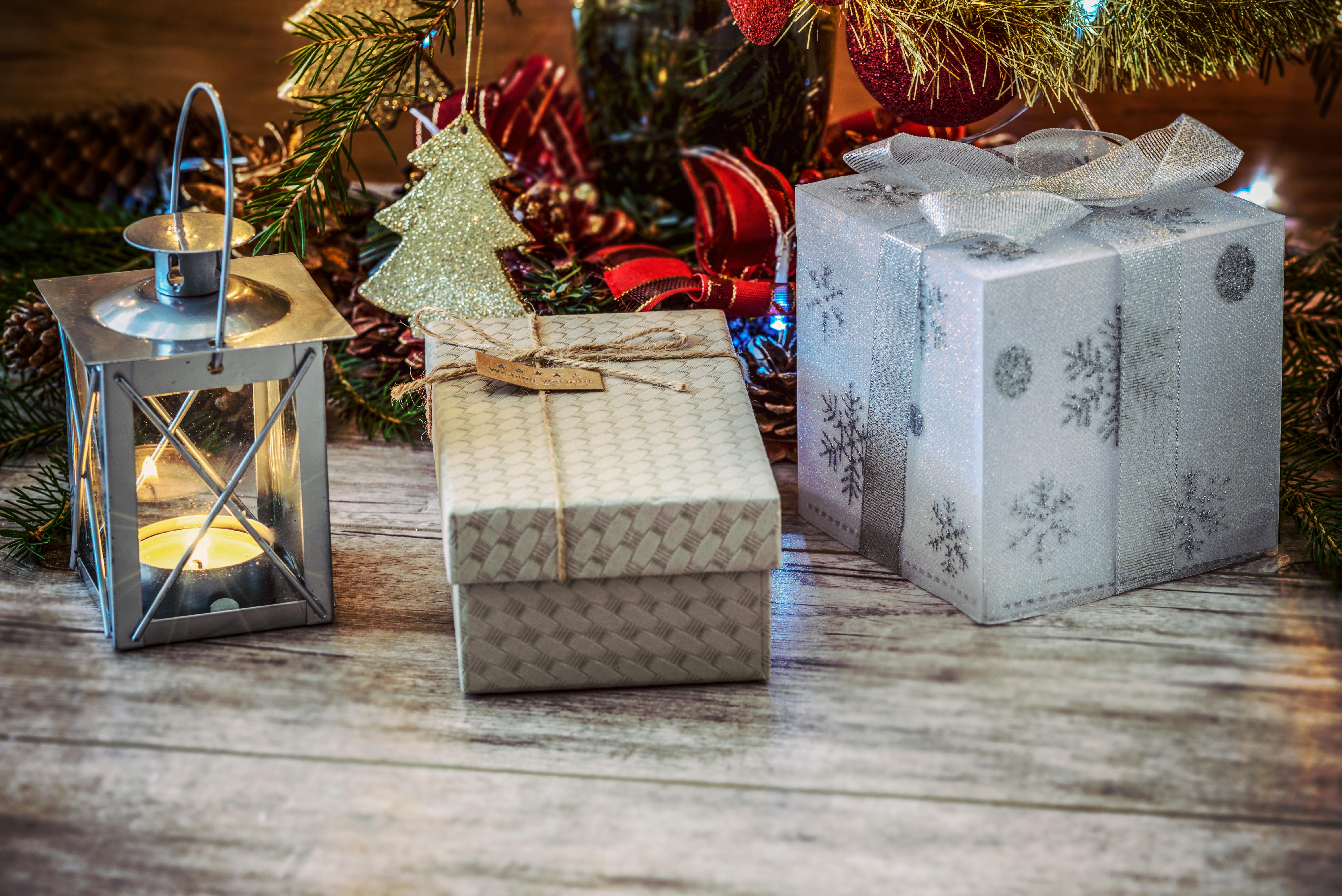 two gray and beige gift boxes beside gray metal lantern