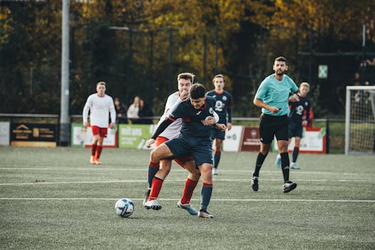 Players in action during an outdoor soccer match on a grass field.