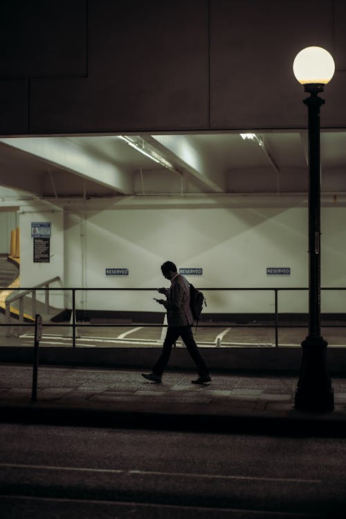 Man Walking on Sidewalk