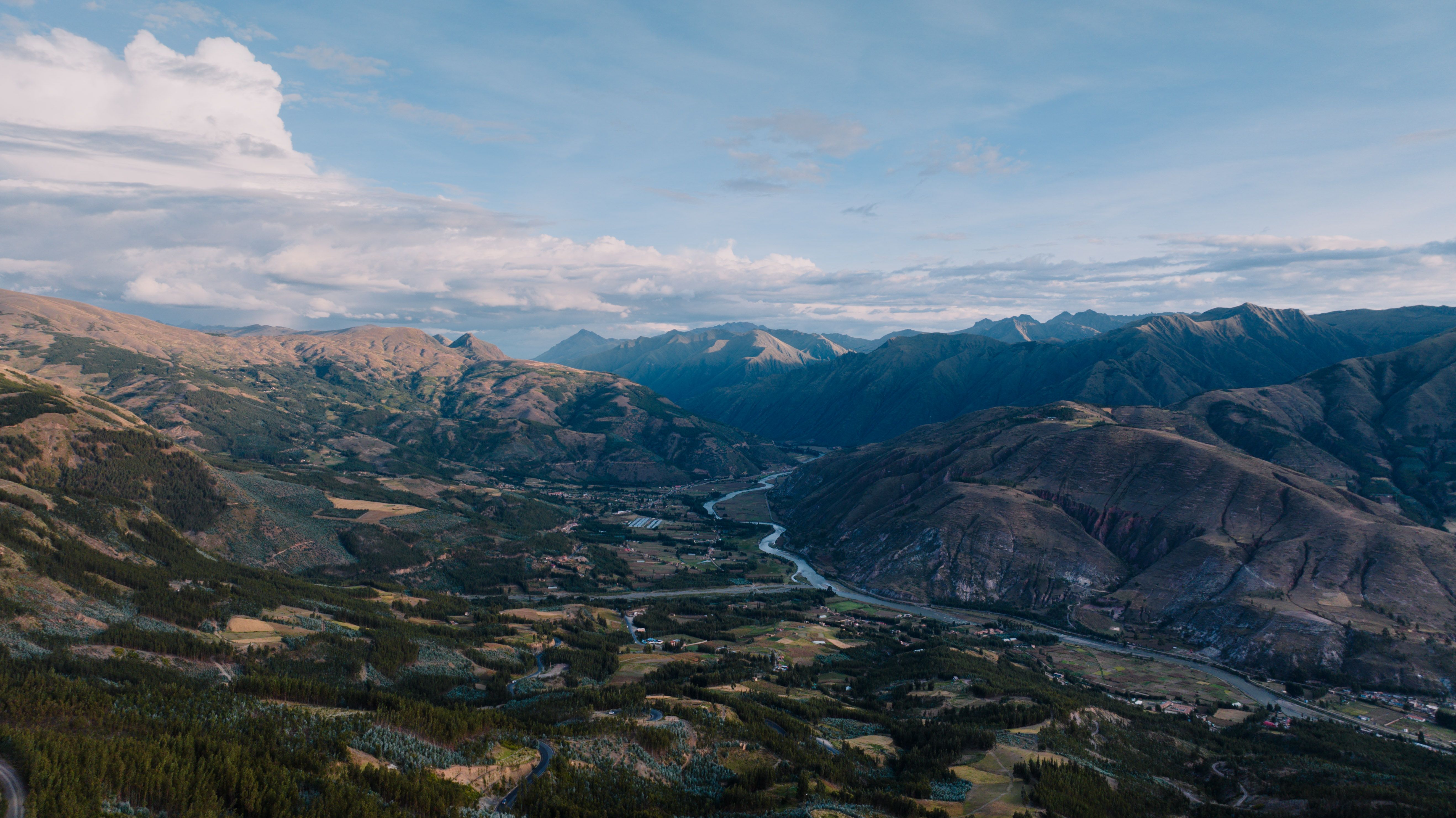 Spectacular Rainbow Mountain Tour from Cusco | Vinicunca Hike | Optional 8AM Review 2026 - Explore the scenic beauty of Cusco's mountain range with a stunning aerial view featuring lush valleys and winding rivers.